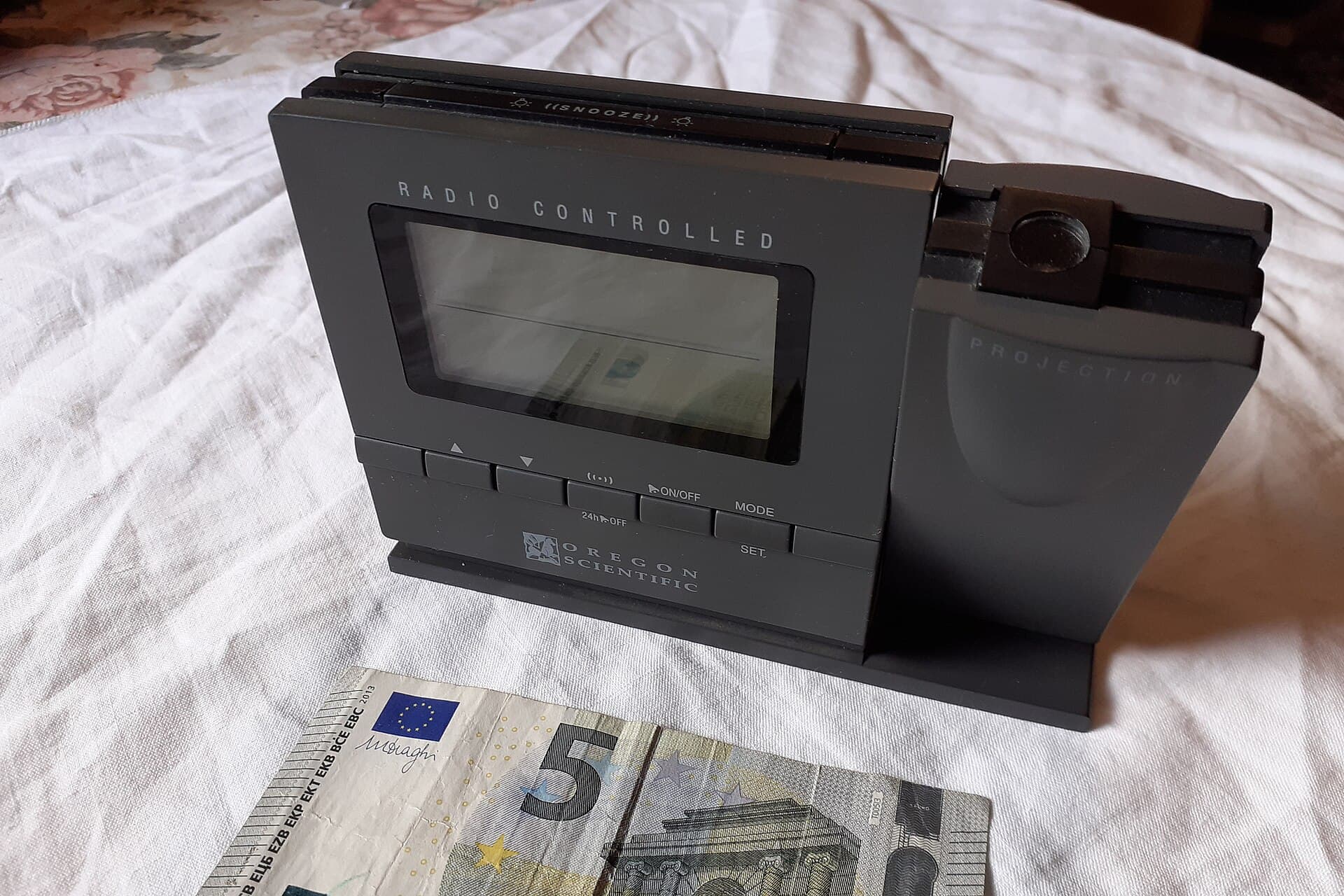 Digital alarm clock on a bedside table, suggesting irregular or night-shift sleep schedules.