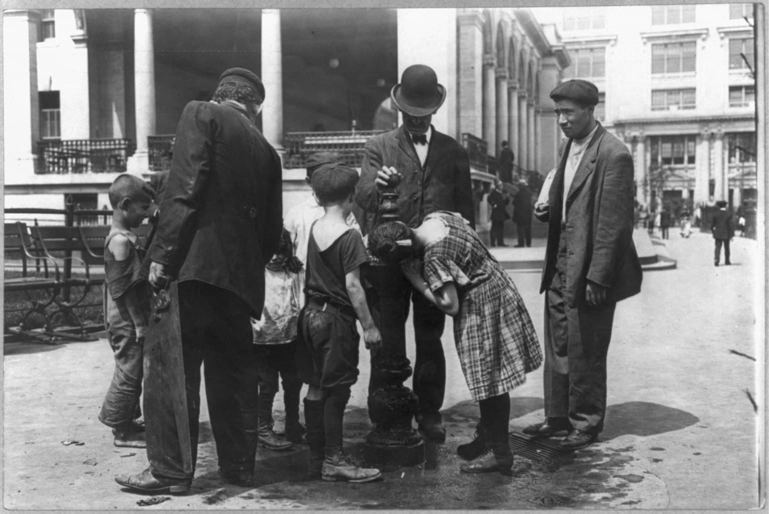 Title: New York City - children on the street: hot weather street scene - On a hot day - people drinking water at a fountain Abstract/medium: 1 photographic print.