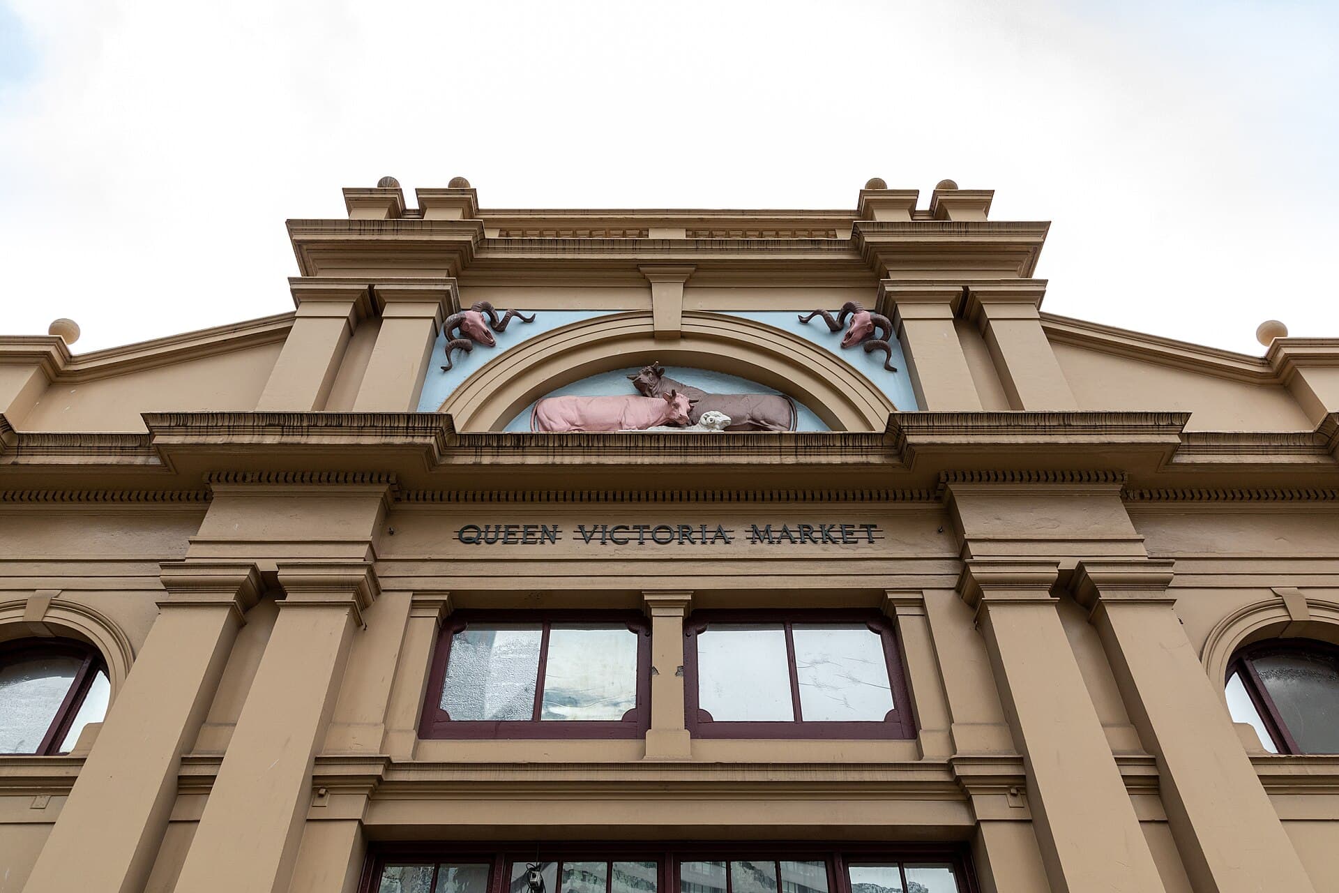 Queen Victoria Market in Melbourne, with produce stalls and a working morning crowd.
